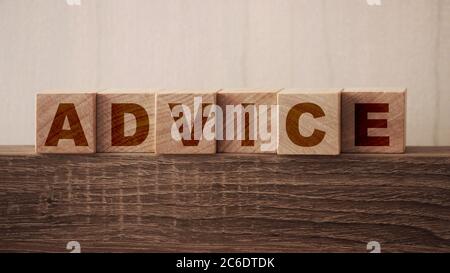 Advice word on wooden cubes on a table. Consulting business concept