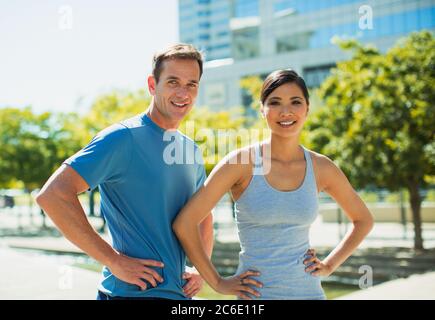 Smiling joggers in urban park Stock Photo