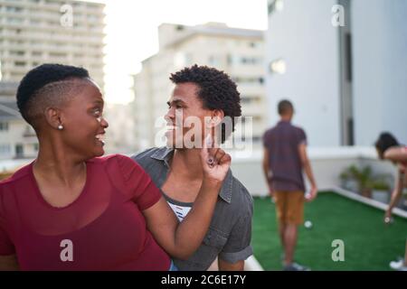 Happy young couple dancing on urban rooftop Stock Photo