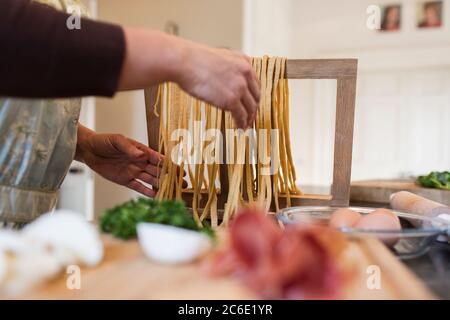 Woman making fresh homemade pasta in kitchen Stock Photo