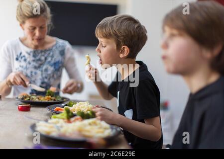 Family eating lunch at dining table Stock Photo