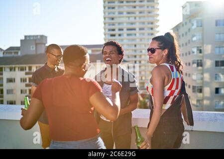 Happy young friends dancing on urban rooftop balcony Stock Photo