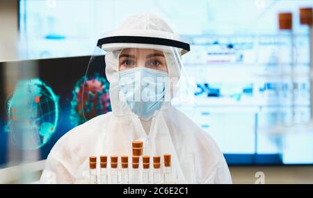 Portrait female scientist in clean suit studying coronavirus vaccine