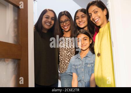 Portrait happy Indian women and girls in doorway Stock Photo