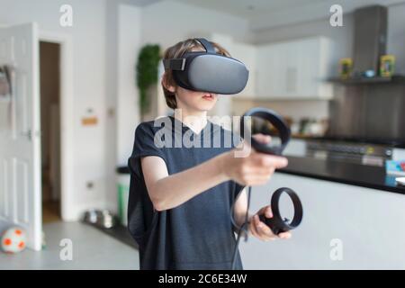 Boy with VRS goggles playing video game Stock Photo
