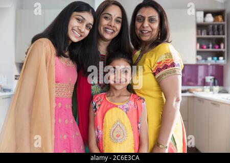 Portrait happy Indian mothers and daughters in saris Stock Photo