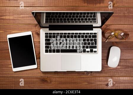 office stuff with notepad, laptop and coffee cup mouse notepad top view shot. Stock Photo