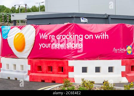 New Lidl shop, store under construction in Southend on Sea, Essex, UK. Delayed by COVID-19 Coronavirus lockdown. Advertising banner, egg cracking on Stock Photo