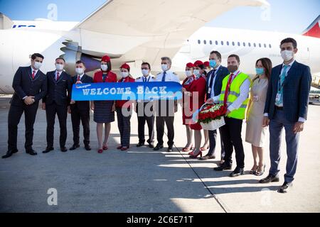 Kyiv, Ukraine - July 1, 2020: Personnel - captains, pilots and flight attendants in medical masks. Airplane on the platform of Boryspil International Stock Photo