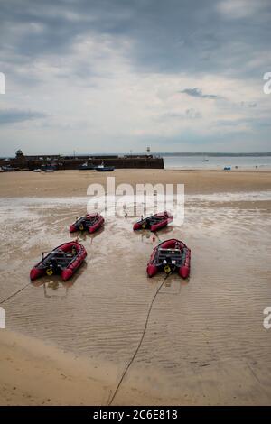 View of boats in St. Ives beach at low tide in Cornwall in England Stock Photo