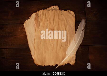 Magical writings, piles, aged paper, candles, wooden brown background Halloween celebration Stock Photo