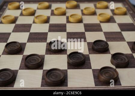 Game of checkers, ancient strategy game consisting of a chessboard and light and dark pawns that challenge each other on it Stock Photo