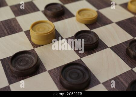 Game of checkers, ancient strategy game consisting of a chessboard and light and dark pawns that challenge each other on it Stock Photo