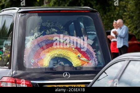 A rainbow floral tribute in one of the hearses in the funeral procession of Fiona Gibson, 12, Alexander James Gibson, eight, and five-year-old Philip Gibson, the three children who died in a house fire in Paisley, Renfrewshire on June 19. Stock Photo