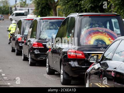 A rainbow floral tribute in one of the hearses in the funeral procession of Fiona Gibson, 12, Alexander James Gibson, eight, and five-year-old Philip Gibson, the three children who died in a house fire in Paisley, Renfrewshire on June 19. Stock Photo