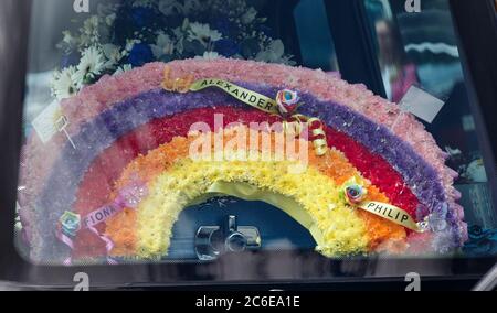 A rainbow floral tribute in one of the hearses in the funeral procession of Fiona Gibson, 12, Alexander James Gibson, eight, and five-year-old Philip Gibson, the three children who died in a house fire in Paisley, Renfrewshire on June 19. Stock Photo