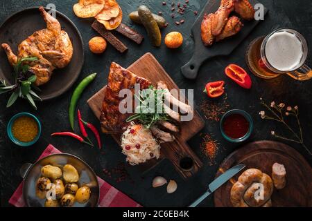 Barbecue pork ribs with bbq sauce sliced on a wooden board with beer mug. Top view flat lay Stock Photo