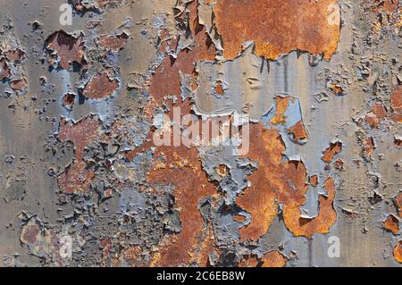 Old, rusty, rough metal texture covered in patches of peeling off old paint Stock Photo