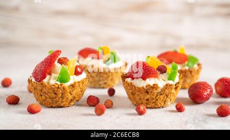 Oatmeal cooked baskets with cottage cheese and fruits. Healthy breakfast oatmeal cups. Romantic food. Cook at home Stock Photo