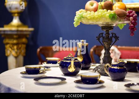 Old porcelain tea set on the table. Stock Photo