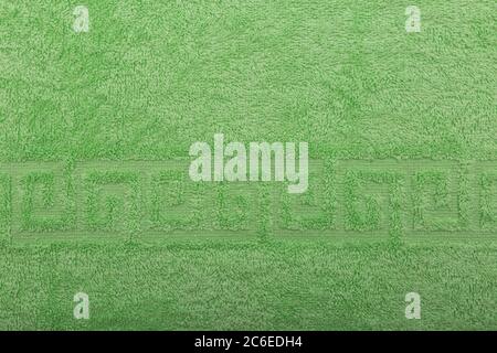 Terry towel, texture, textile background close up. Terry green towel background. Color green terry towel made of cotton fabric. Structure with uncut Stock Photo