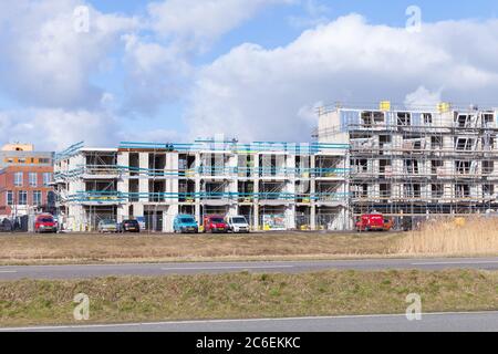 Amsterdam, Netherlands - February 24, 2017: Modern living houses are under construction under blue cloudy sky Stock Photo