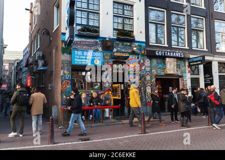 Amsterdam, Netherlands - February 24, 2017: Street view of old Amsterdam with people walking near coffeeshop Bulldog Stock Photo