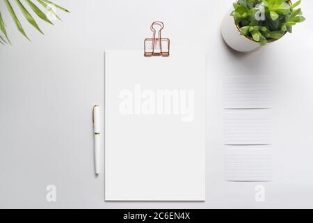 Blank corporate identity stationery set, personal branding mockup template. Sheets of paper, fountain pen and office supplies, decorated with green pl Stock Photo