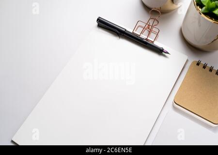 clipboard with golden clip, branding stationery mockup and fountain pen, with holographic tip on light background. Corporate modern items set Stock Photo