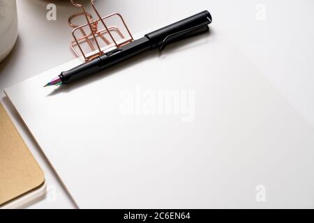 clipboard with golden clip, branding stationery mockup and fountain pen, with holographic tip on light background. Corporate modern items set Stock Photo