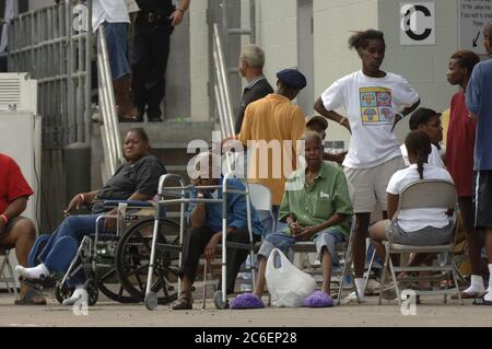 Austin, Texas USA, September 4, 2005: Hurricane Katrina refugees crowd around the rear entrance of the Austin Convention Center, where 4,000-plus evacuees have arrived, most from the hard-hit New Orleans area.  ©Bob Daemmrich Stock Photo
