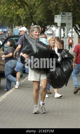 Austin, Texas USA, September 3, 2005: Karen Hughes, U.S. Undersecretary of State for Public Diplomacy, helps unload relief supplies outside the Austin Convention Center as thousands of Hurricane Katrina refugees continued to pour into Texas. ©Bob Daemmrich Stock Photo