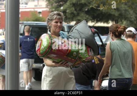 Austin, Texas USA, September 3, 2005: Karen Hughes, U.S. Undersecretary of State for Public Diplomacy, helps unload relief supplies outside the Austin Convention Center as thousands of Hurricane Katrina refugees continued to pour into Texas. ©Bob Daemmrich Stock Photo