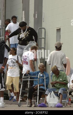 Austin, Texas USA, September 4, 2005: Hurricane Katrina refugees crowd around the rear entrance of the Austin Convention Center, where 4,000-plus evacuees have arrived, most from the hard-hit New Orleans area.  ©Bob Daemmrich Stock Photo