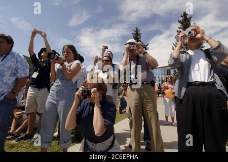 Calgary, Alberta, Canada July 2005: Proud parents and friends take photographs at the finish line of a 10-day cross-country solar car event at the University of Calgary. ©Bob Daemmrich Stock Photo