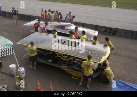 College Station, Texas USA, July 15, 2005: Teams prepare their vehicles for qualifying races for experimental solar cars built by college teams for the North American Solar Challenge 2005. Michigan (foreground) and Queen's University (Canada) in the pit area. ©Bob Daemmrich Stock Photo