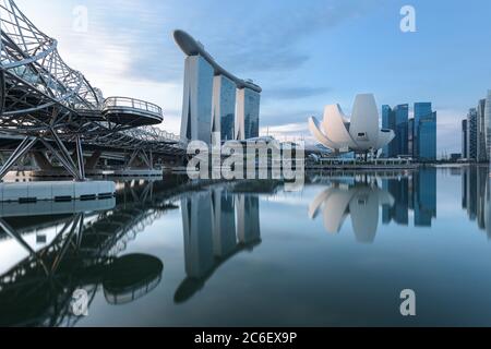 Singapore, 19 Dec 2019: a sunrise skyline view of the Marina Bay with the Helix Bridge, the Marina Bay Sands hotel and the Central Business District i Stock Photo