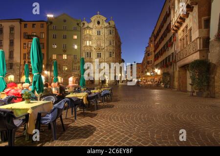 Night scene in downtown Innsbruck, Austria along the Herzog Friedrich Street. On the left, the Golden Roof (Goldenes Dachl), although not fully vissib Stock Photo