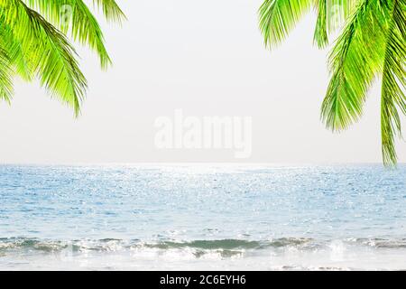 Blurred blue sky and sea with bokeh light and white wooden table background. Stock Photo