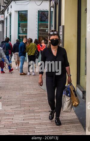 Cork, Ireland. 9th July, 2020. A woman wears a face mask in Cork city to protect herself from Covid-19. Credit: AG News/Alamy Live News Stock Photo
