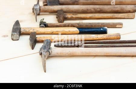 Set of vintage well used hand construction tools for handyman, hammers, on a wooden background Stock Photo