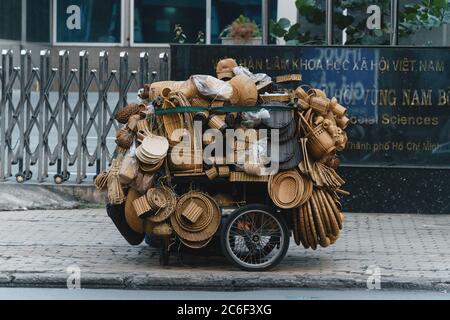 Ho Chi Minh city (Saigon), Vietnam - 09 July 2020:a man selling handicrafts, rattan baskets, pillows, decorations ... on a cart in Ho Chi Minh City, V Stock Photo