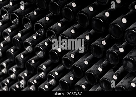 Bottles of Argentine wine symmetrically stored in a winery from a vineyard in the province of Mendoza. Black and white picture Stock Photo