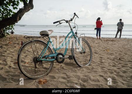 Badung, Bali, Indonesia. 9th July, 2020. A bicycle parks at the beach sand. Local government start to reopen famous tourism icon of Kuta Beach for Bali citizens as a stage of ''new normal'' plan. Kuta Beach has been closed since March 30, 2020 due to Covid-19 coronavirus concern. Credit: Dicky Bisinglasi/ZUMA Wire/Alamy Live News Stock Photo