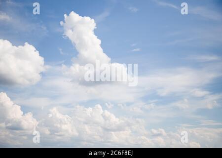 White clouds float across the light blue sky Stock Photo