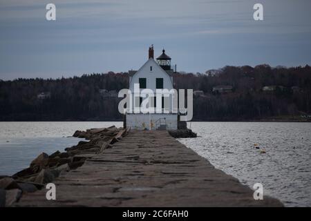 The Rockland Breakwater Lighthouse sits at the end of the Rockland Breakwater in Camden, Maine.  It is a popular hike and tourist destination. Stock Photo