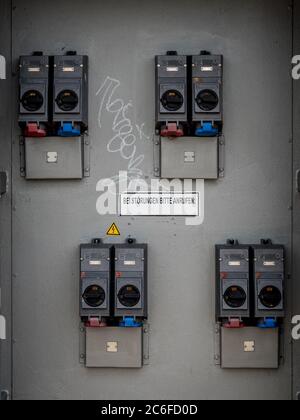 industrial high voltage switches with information sign, please call if there is a malfunction. bei stoerungen bitte anrufen in german language Stock Photo