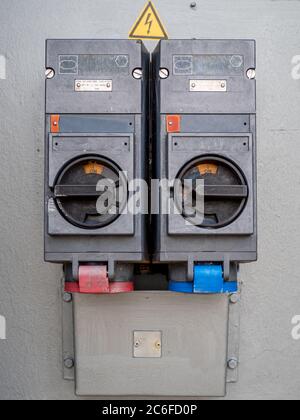two old industrial high voltage switches on gray background Stock Photo