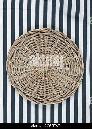 Round Retro Style Wicker Pattern Trivet at Vertical Strips Cloth Stock Photo