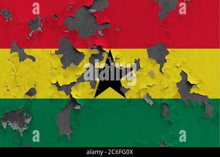 Ghana flag close up painted, damaged and dirty on wall peeling off paint to see concrete surface. Vintage National Concept. Stock Photo